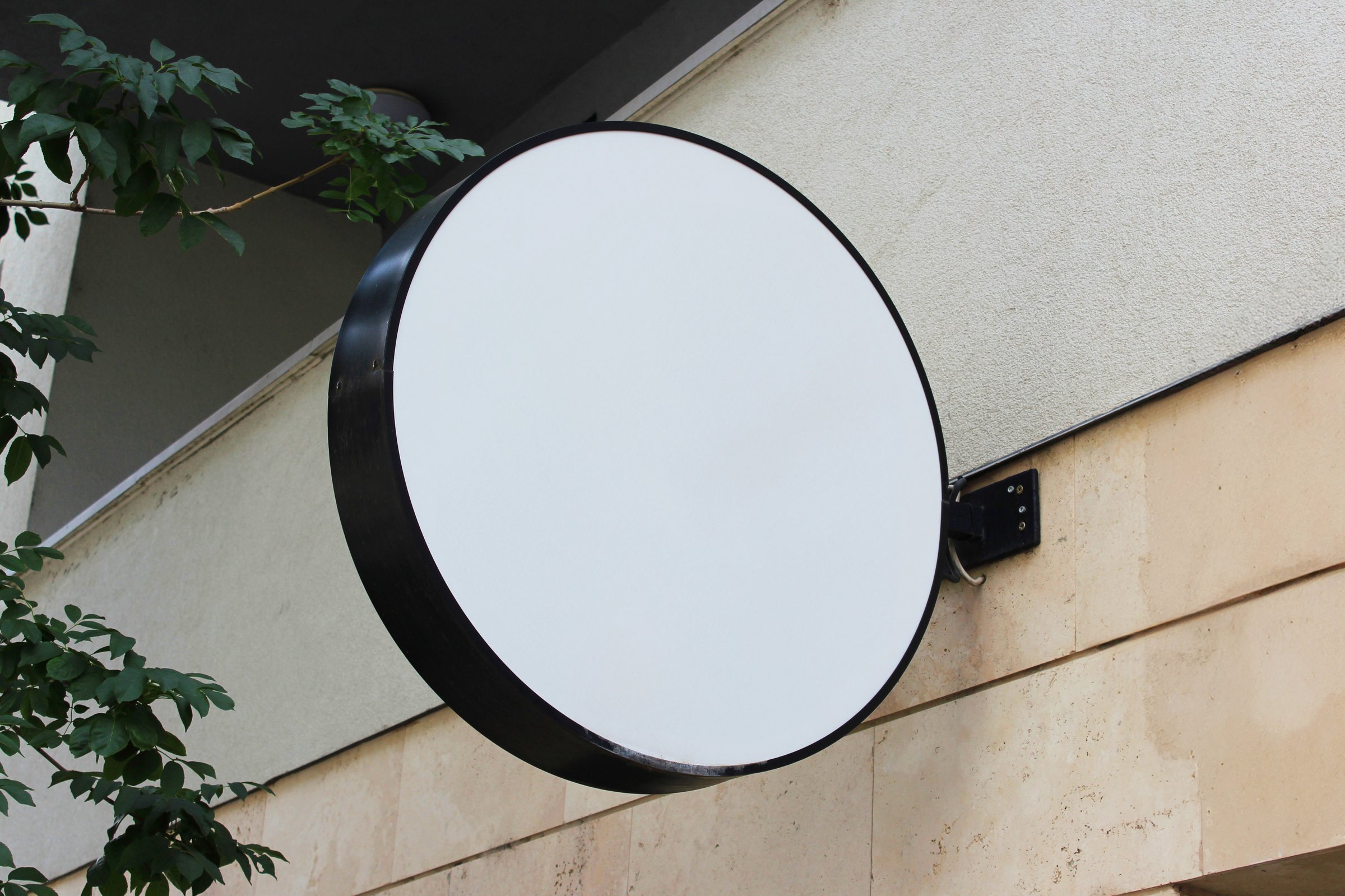 Rounded Street storefront shop, cafe, restaurant mounted signboard mock up design template. Blank white store sign design mockup.