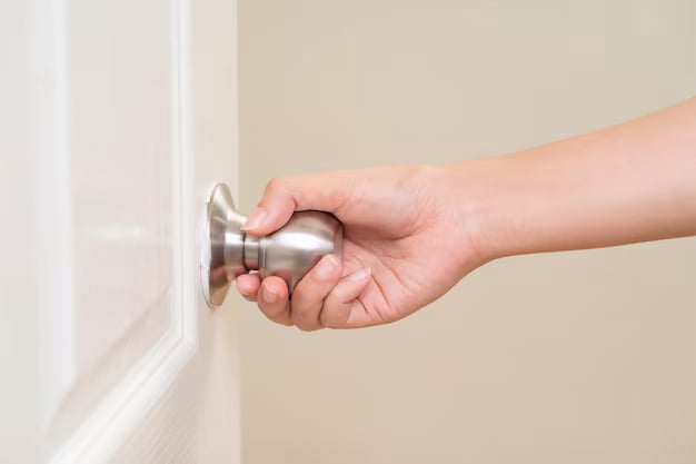 Woman hand holding doorknob
