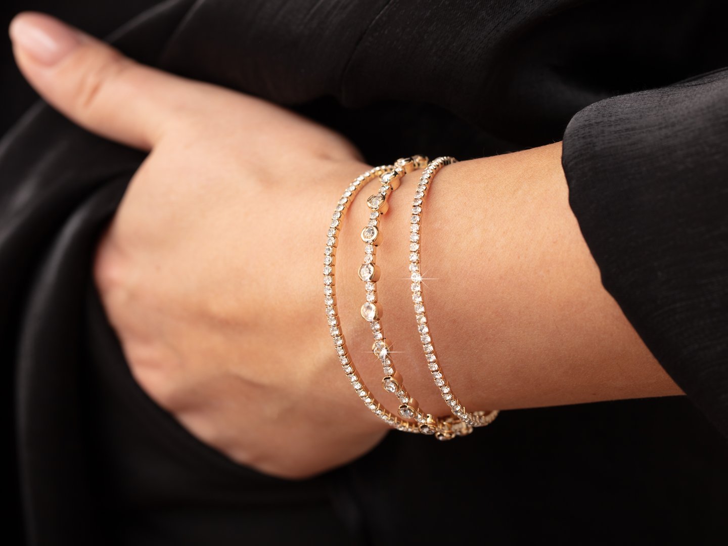 A bracelet with precious stones on a girl's hand.