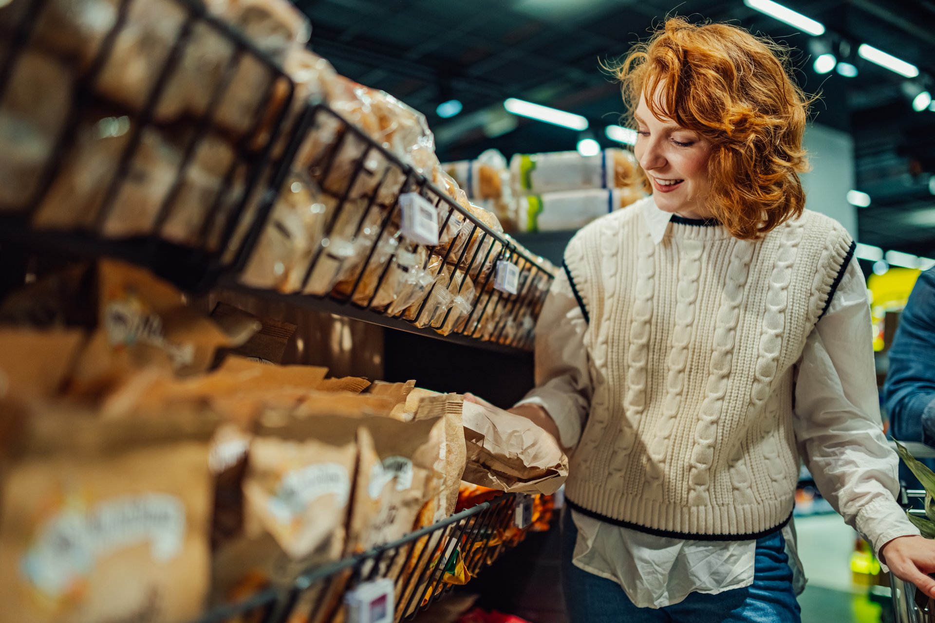 Smiling customer buying groceries in a supermarket