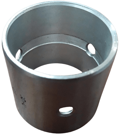 A cylindrical metallic spacer with several holes near the top and bottom edges viewed from an angle.