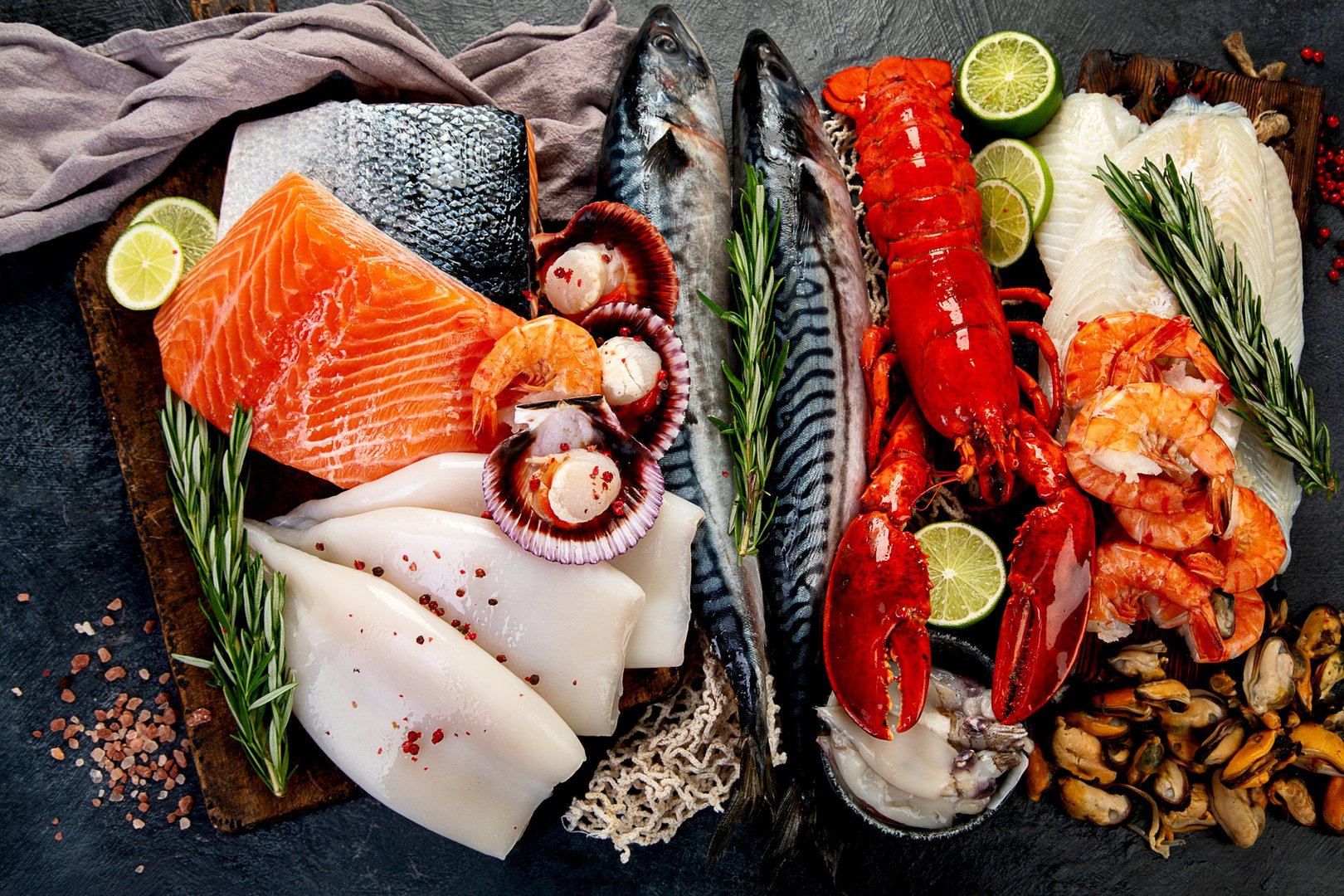 Variety of fresh seafood and herbs. Fresh fish and seafood arrangement. Top view.