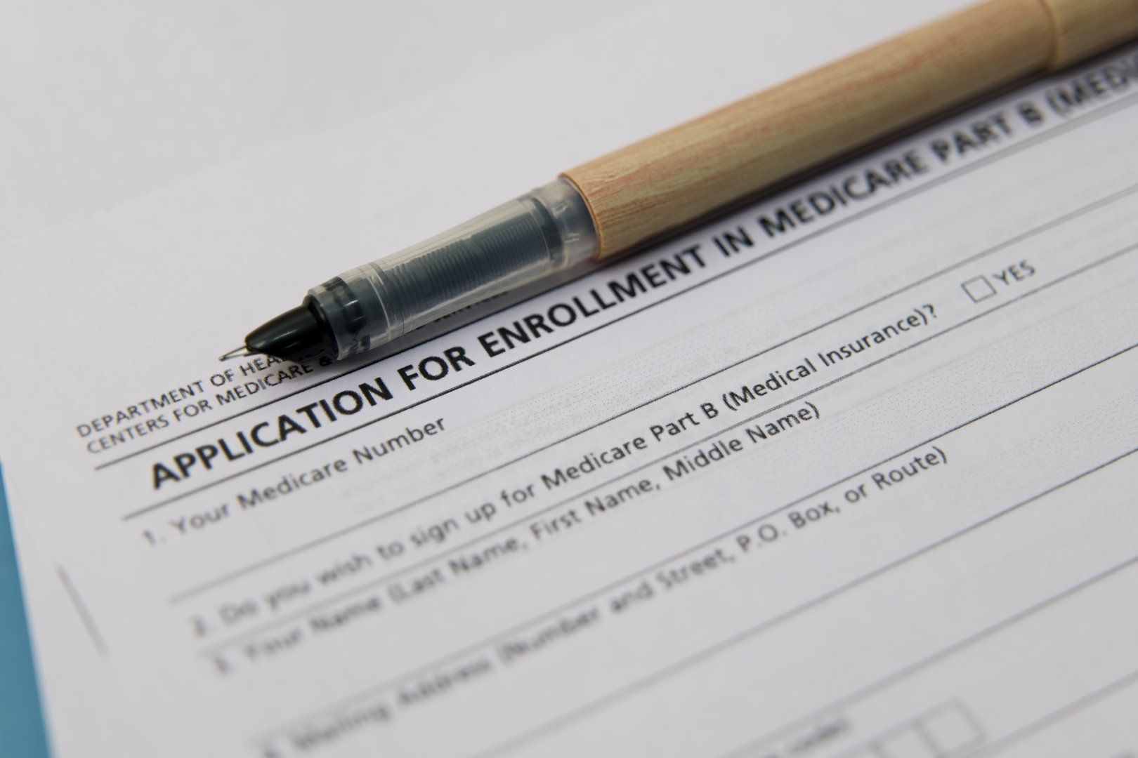 Medicare enrollment form with pen