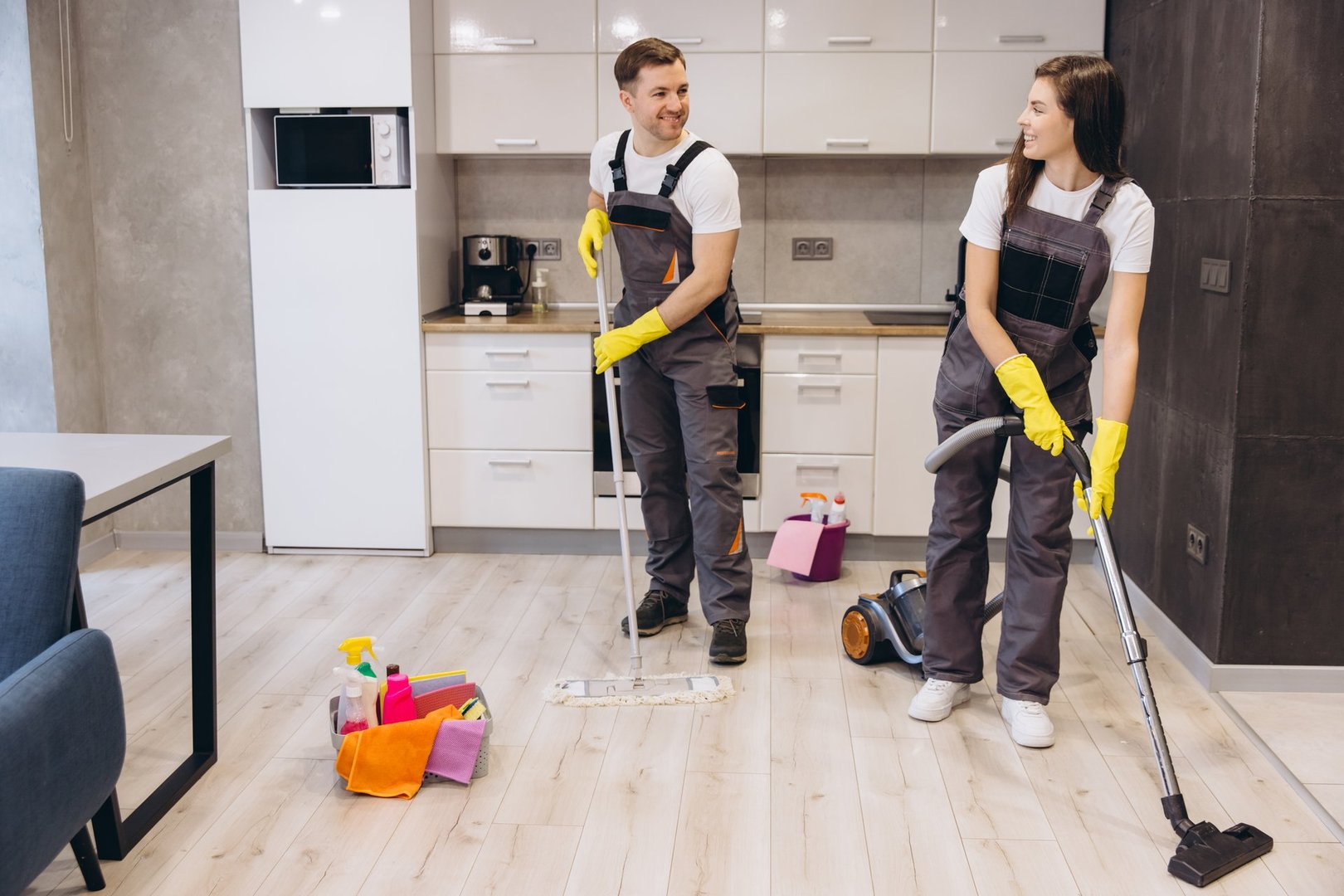 Professional cleaners washing floors and vacuuming in a modern apartment, ensuring a spotless and hygienic living space with teamwork