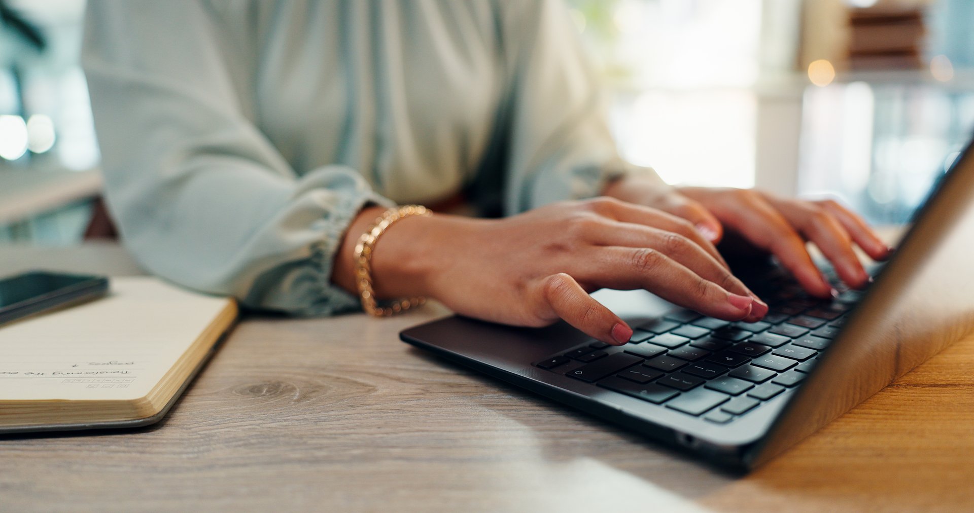 Business woman, laptop and hands with typing for press release in office with digital job. Website, brand administration and professional with research and online planning for project with internet