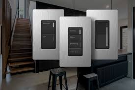 Three modern light switches with different button configurations, set in a contemporary indoor setting with stairs.