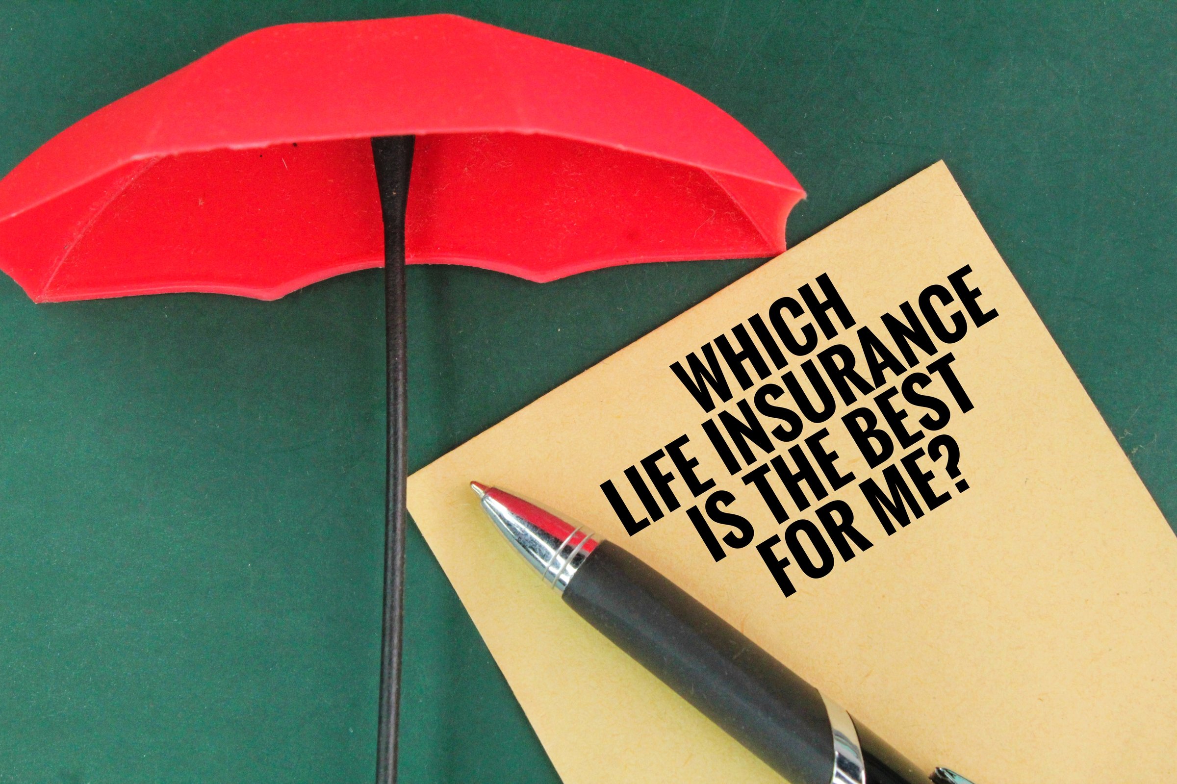 an umbrella, a pen and a book with the question word WHICH LIFE INSURANCE IS THE BEST FOR ME? insurance coverage concept