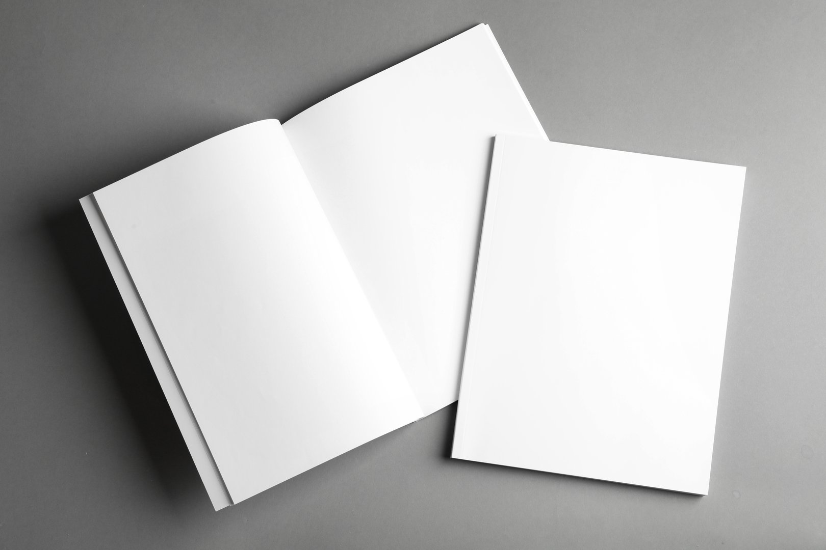 Blank Brochure Mockup, Top View on Gray Background.