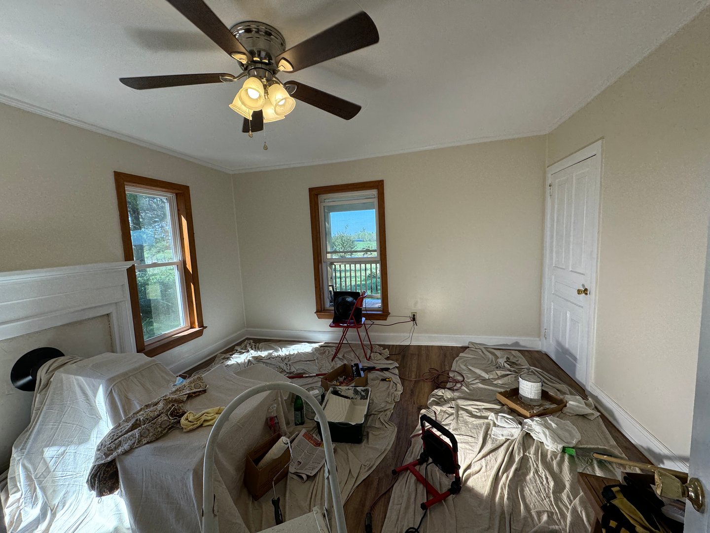 Drop cloths and paint in a freshly painted room