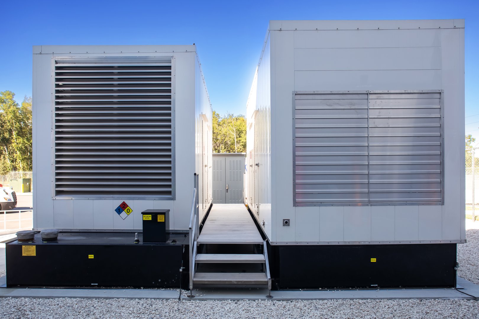 close up view of exterior standby diesel generators outside warehouse