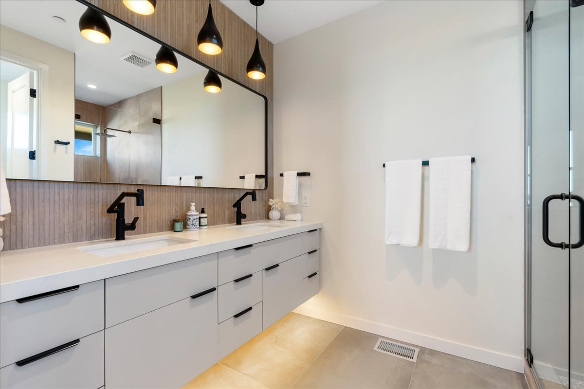 Elegant primary bathroom with vanity and mirrors