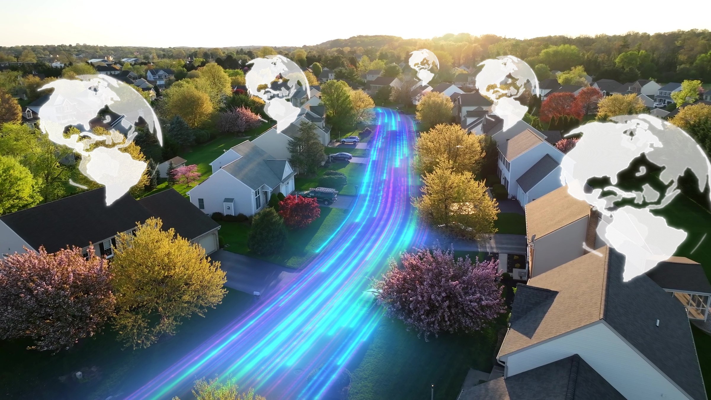 Aerial of a suburban neighborhood with glowing data streams and digital Earth icons projected on rooftops. 3D graphic