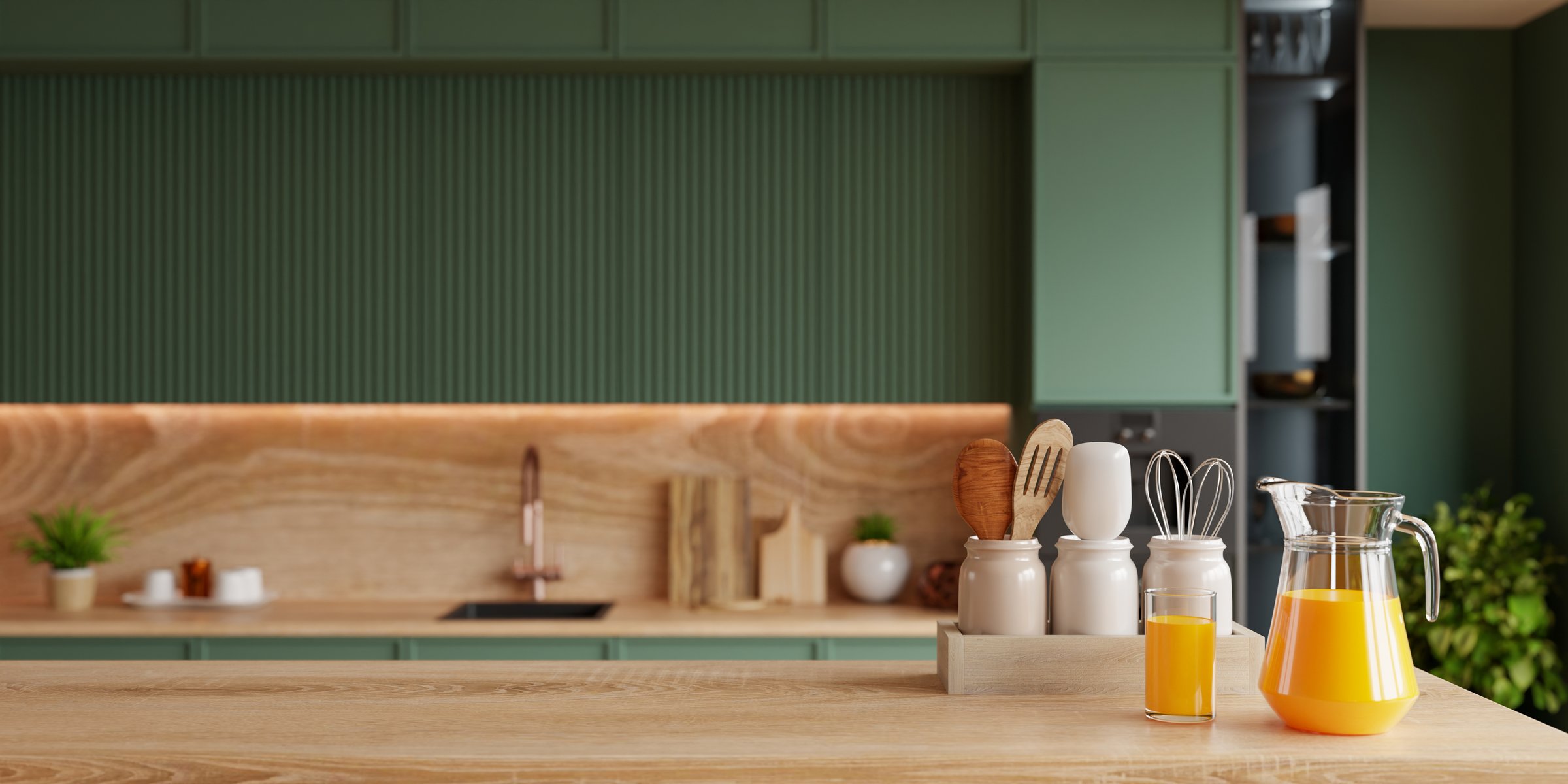 Modern kitchen interior with wooden counter, green cabinets, and fresh orange juice- 3D rendering