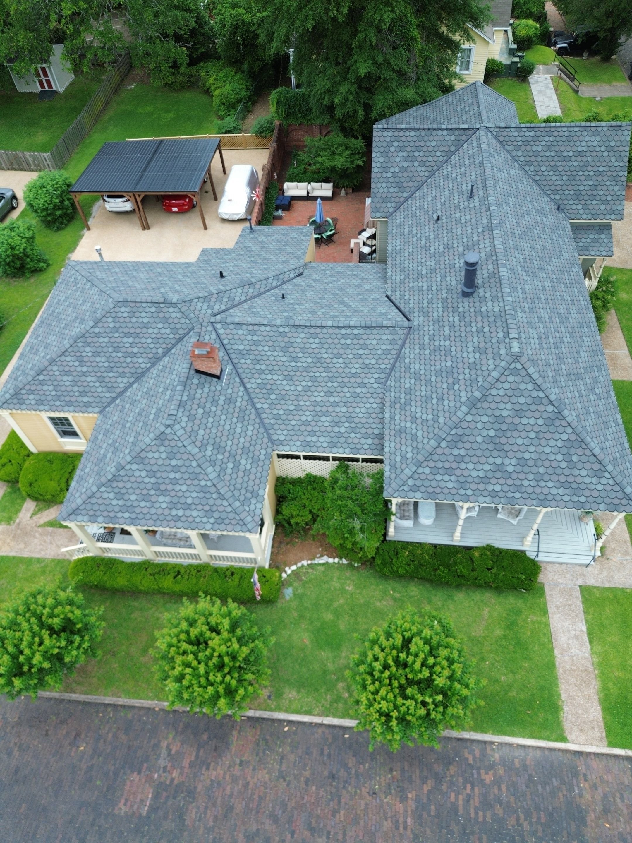 Roofer placing tiles on sloped roof