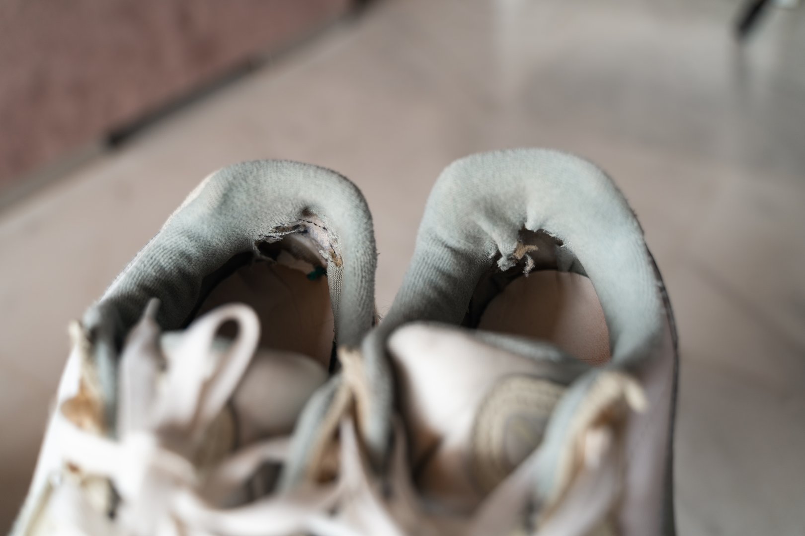 Close-up of well-used sneakers, highlighting the wear and tear, representing the underconsumption core trend focused on sustainability and mindful consumption. High quality 4k footage