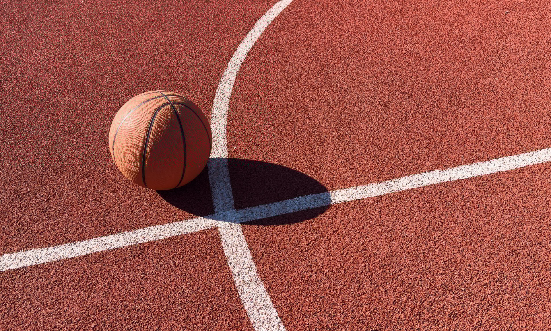 Playing basketball under the sun on the playground at school . High quality photo