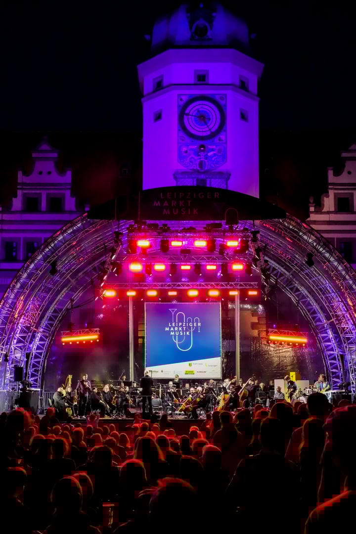 Leipzig, Germany, August 6, 2025. Leipzig Market Music. Music event against the backdrop of the Old Town Hall in Leipzig. Stage orchestra and celebrating people. Atmospheric night shot