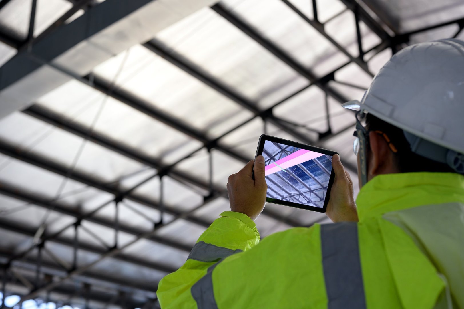 Construction Civil Engineer use technology software through tablets to scan building construction and inspection to show augmented reality in work, Building information model or BIM concept
