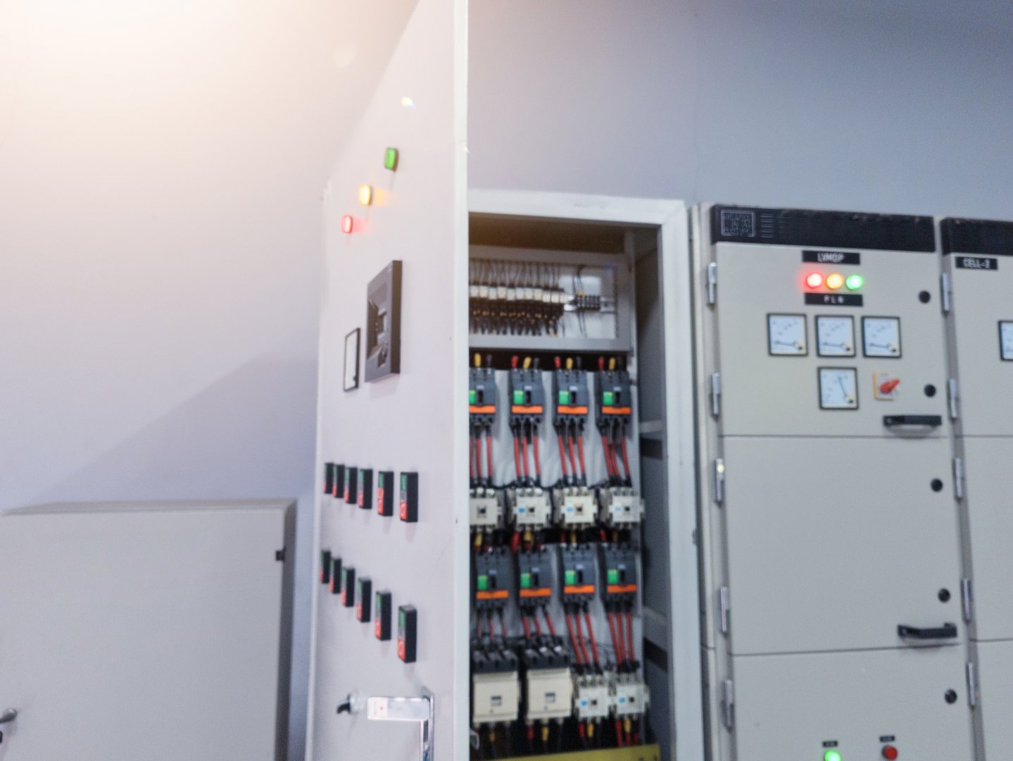 Industrial circuit breaker and  contactors on the main panel distribution, inspection and service concept with open the electrical panel.