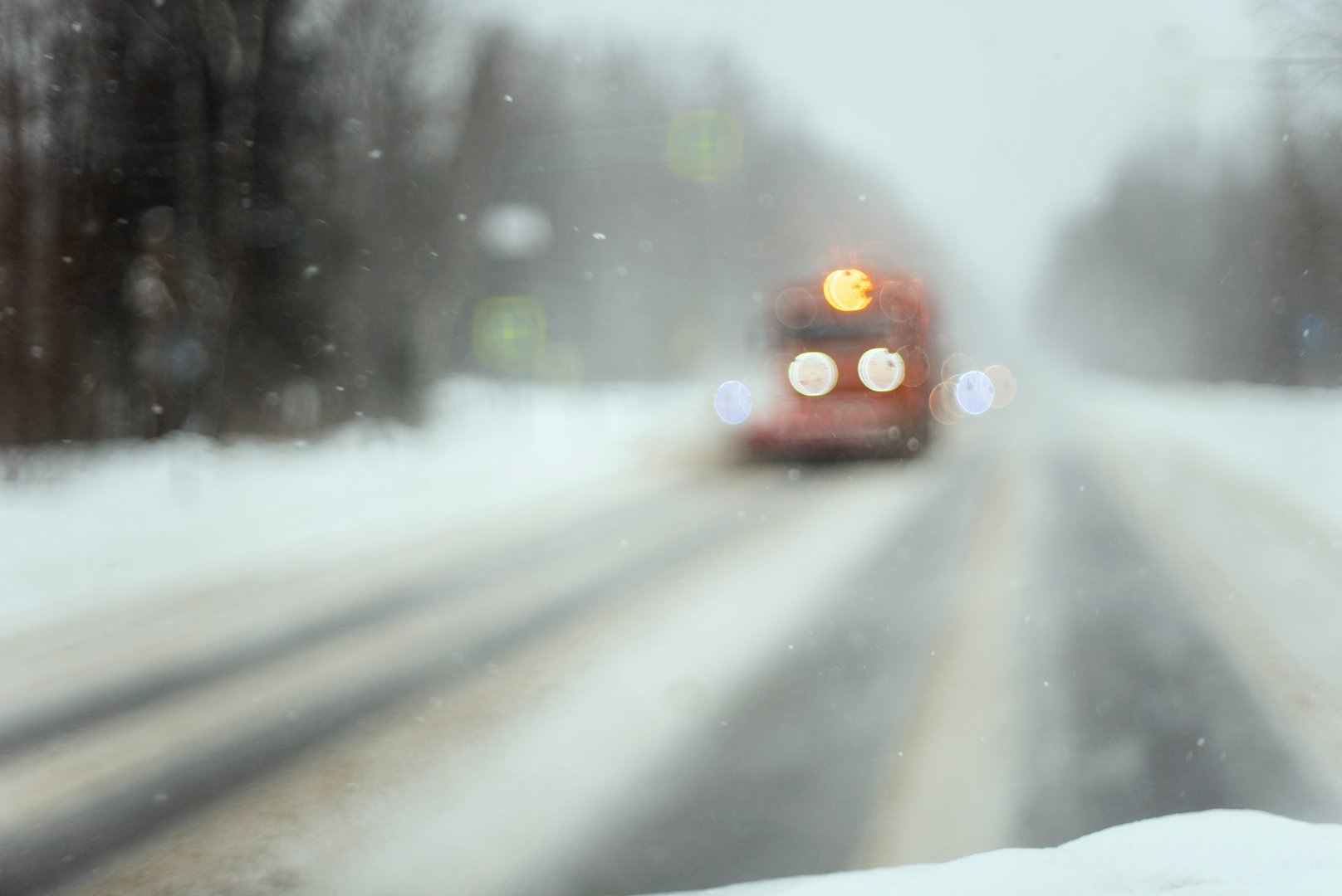 snow plow truck cleaning winter road, a blurred de-focused shot