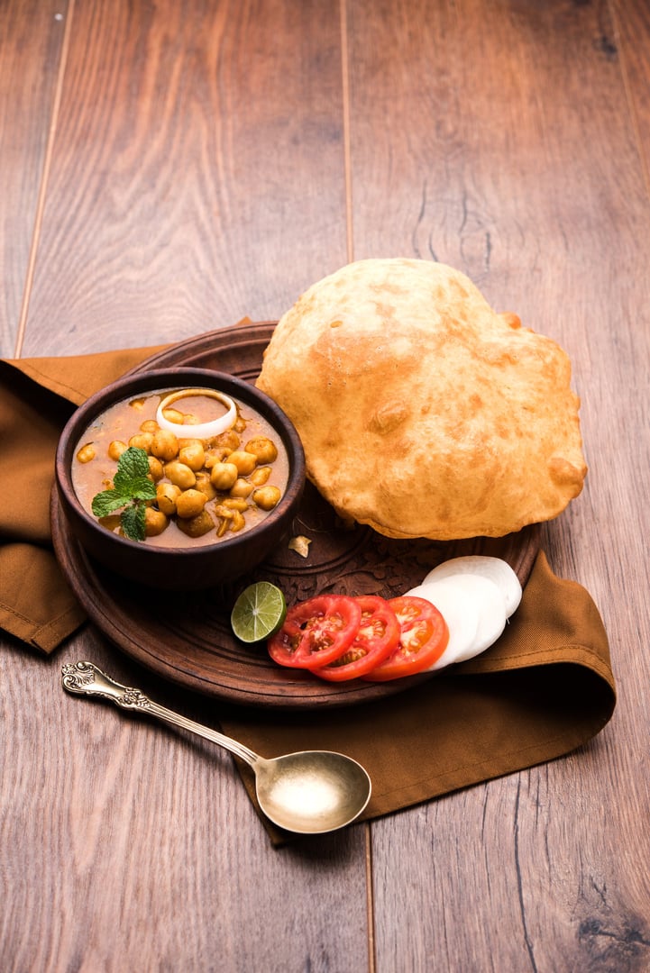 Chole Bhature or Chick pea curry and Fried Puri served in terracotta crockery
