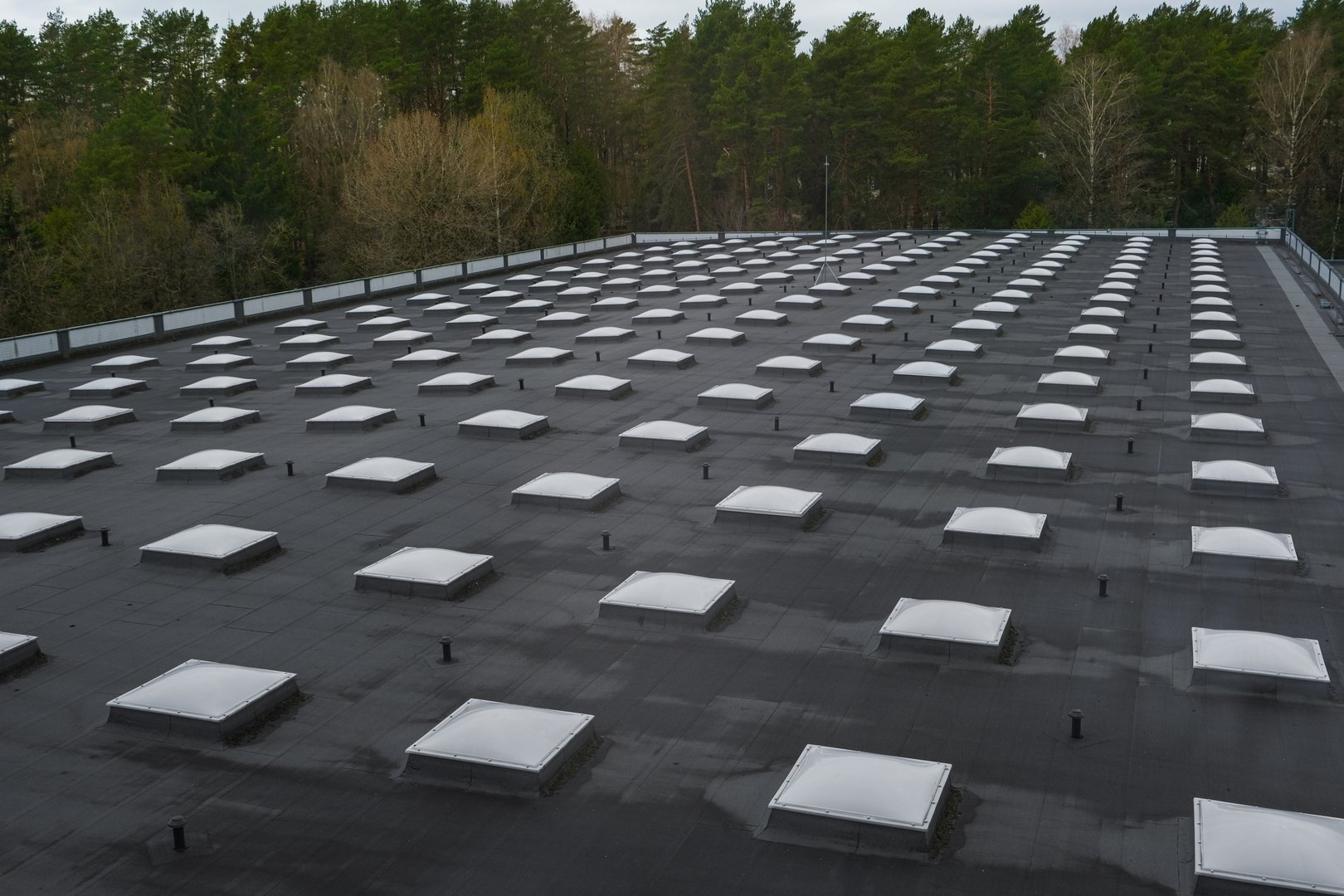Top view of a modern roof with natural light. Skylights. Energy efficiency. Transparent panels on the roof. High quality photo