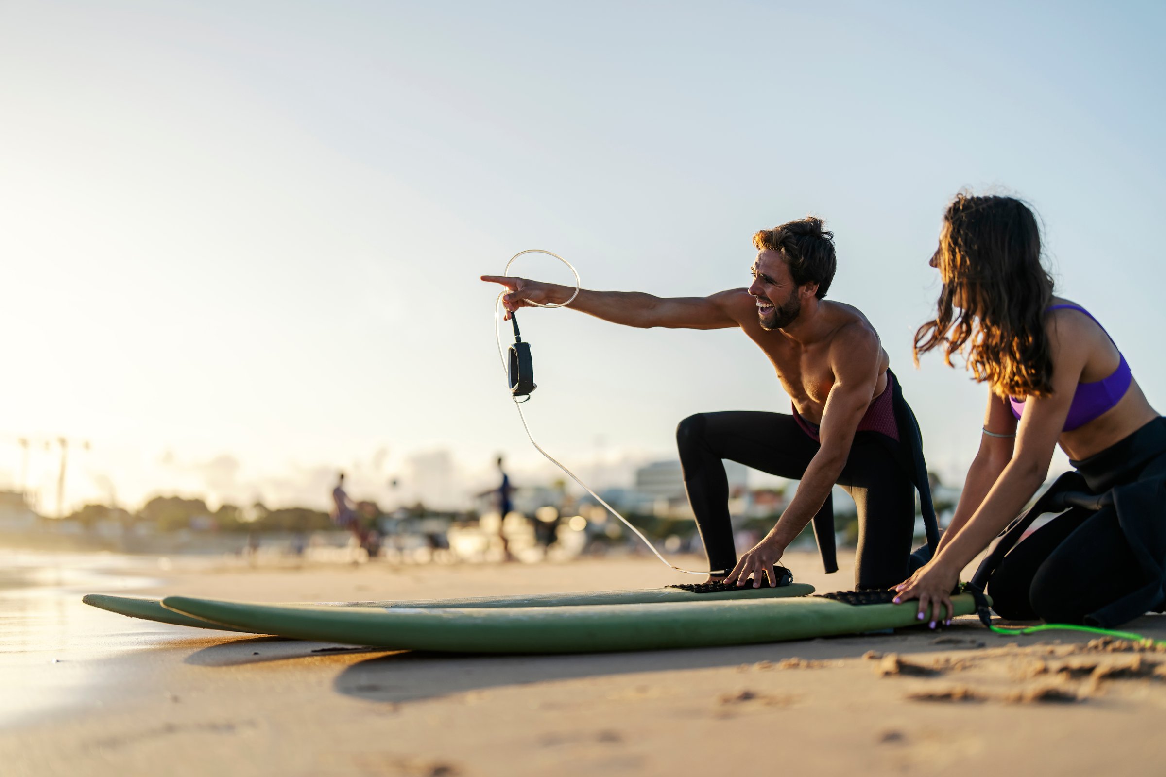 Couple preparing to go surfing