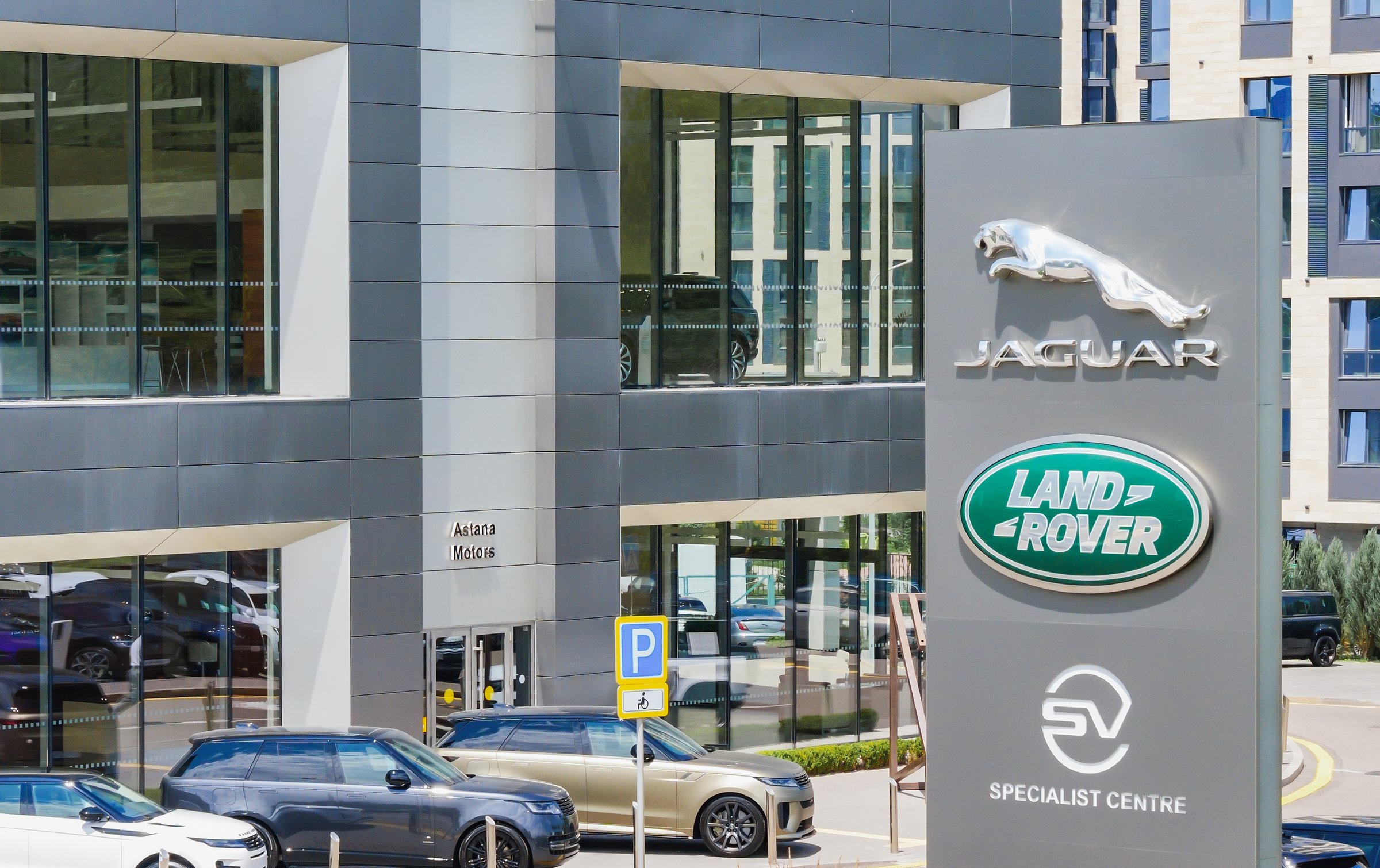 Jaguar Land Rover emblem near the car dealership. Premium class car