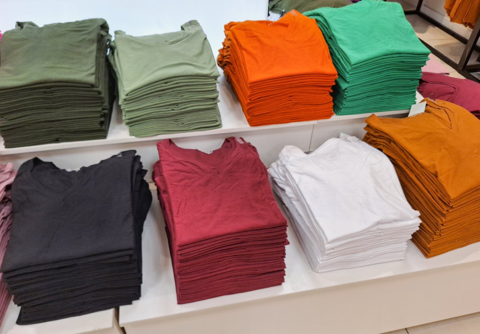 Basic T-shirts displayed in a retail store.