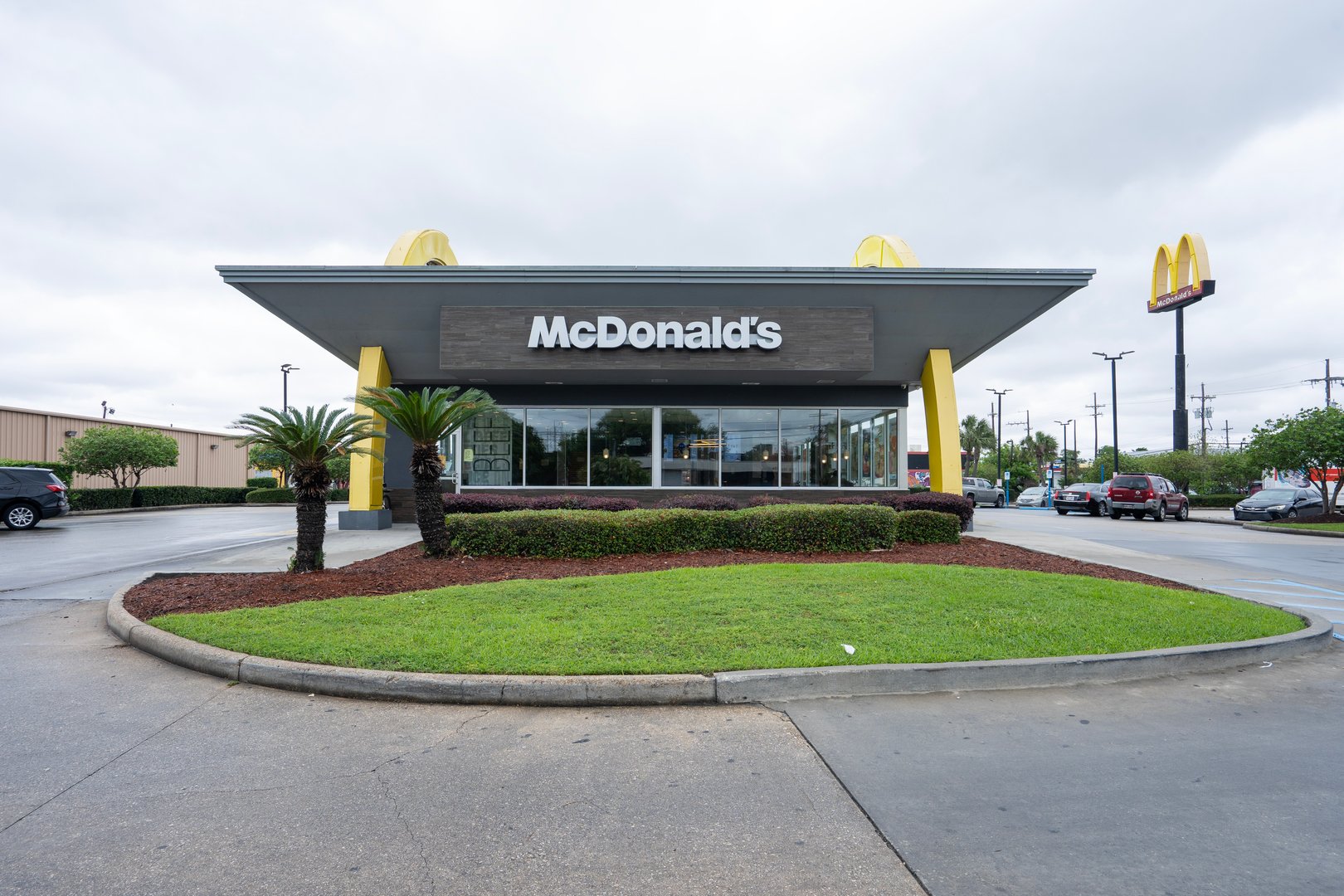 New Orleans, LA, USA - Apr 7, 2025: Front view of a McDonald's restaurant featuring golden arch-shaped structure with rounded, decorative arches, in New Orleans, Louisiana.
