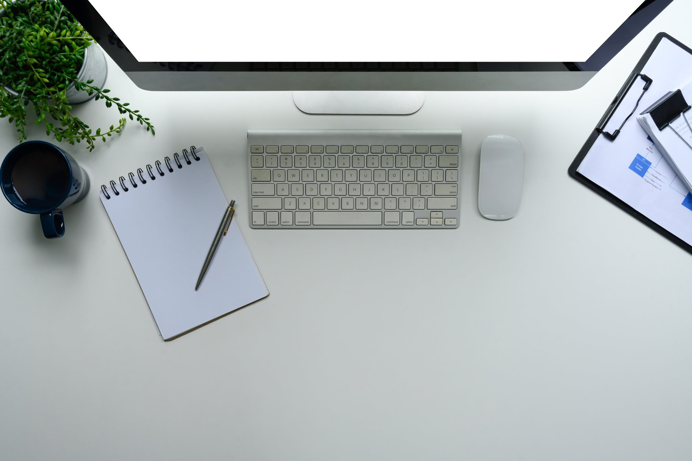 Overhead view of computer accessories and financial charts for productivity concept.