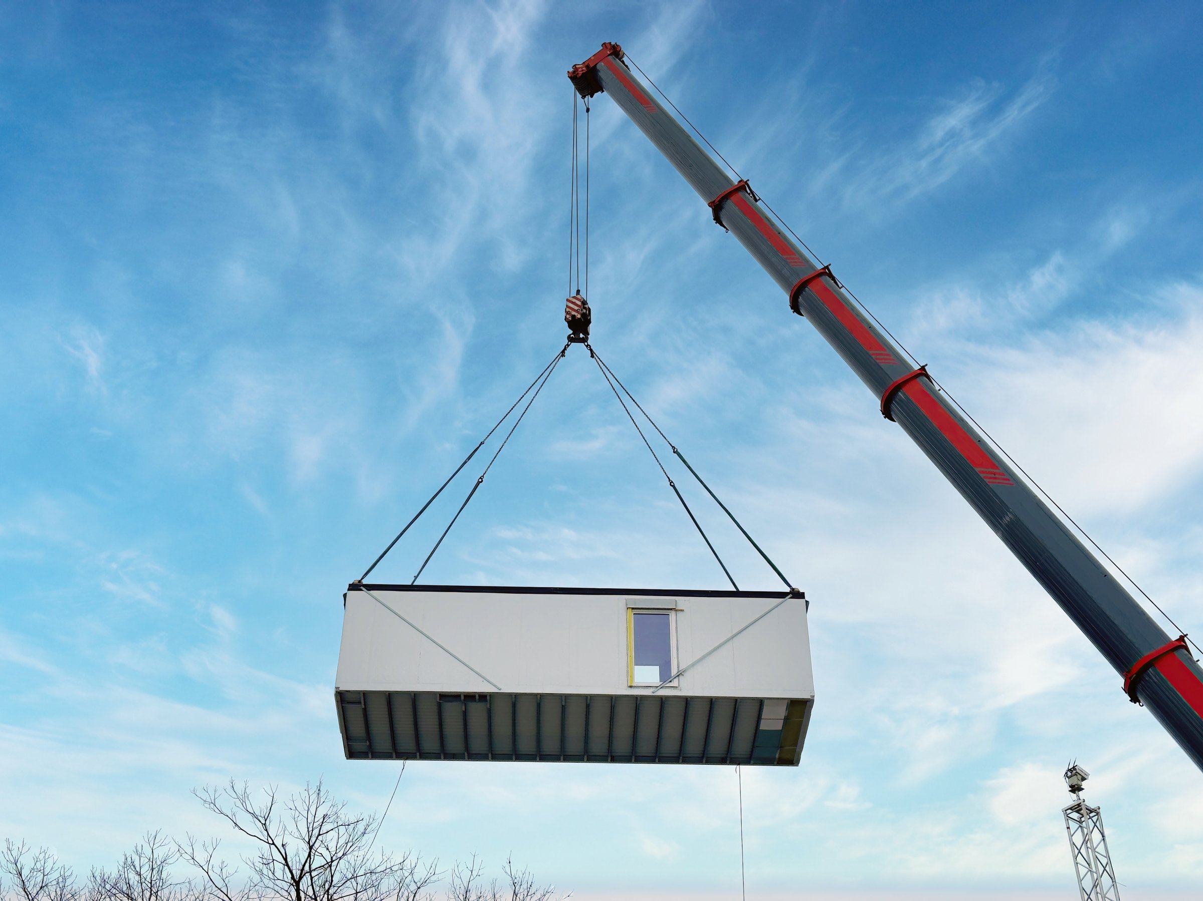 The construction process showcases modern modular architecture and engineering
