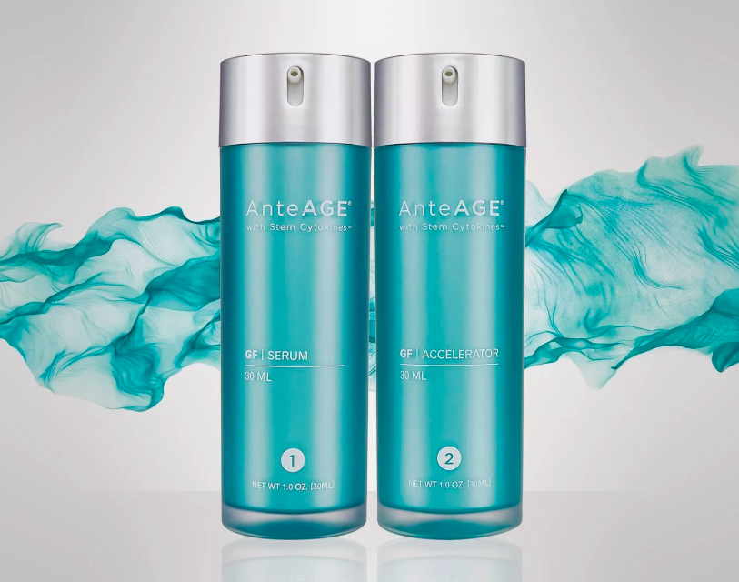 Two AnteAGE skincare bottles labeled GF Serum and GF Accelerator, with a turquoise wave design in the background.