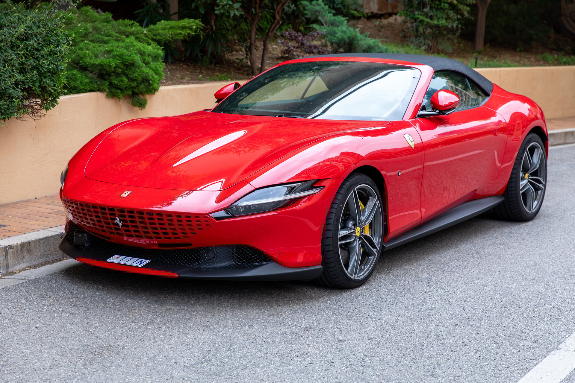 Monte-Carlo, Monaco - June 9, 2024: A sleek red Ferrari Roma sports car parked on a street. The luxurious vehicle stands out with its vibrant color and elegant design, exemplifying automotive excellence and performance.