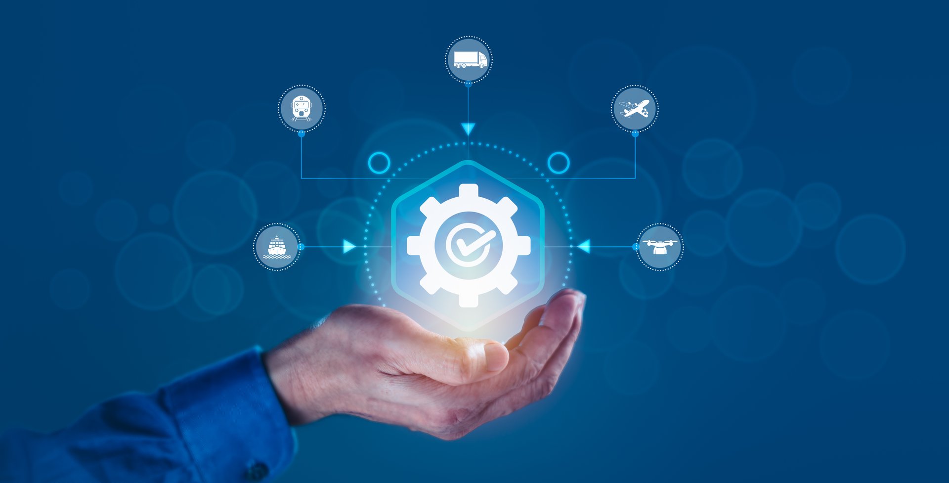 Man's hand supports a gear featuring supply chain icons, including business logistics, delivery, and transportation of global supply chain systems