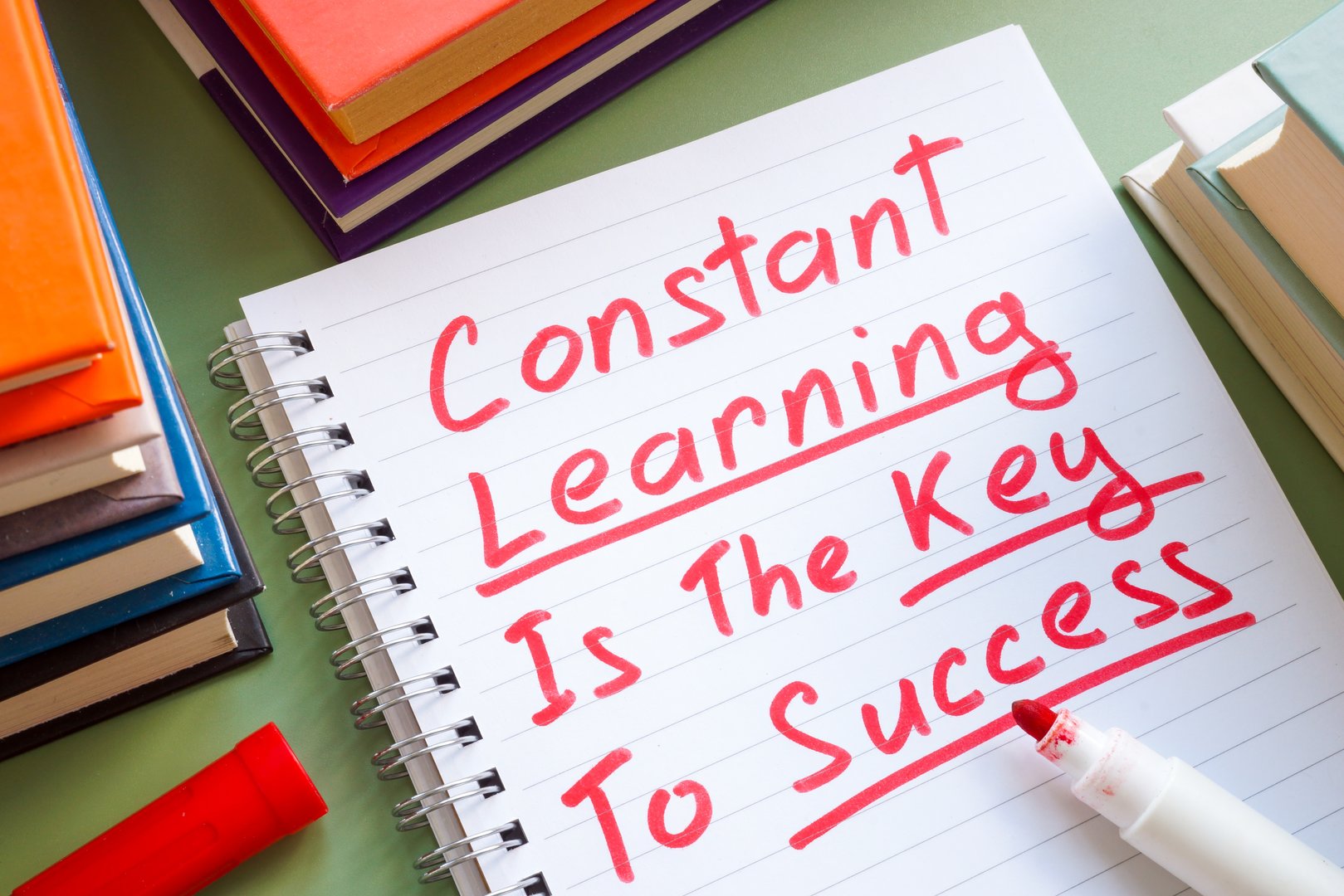 Notebook with constant learning is the key to success. Personal growth and continuous education concept.