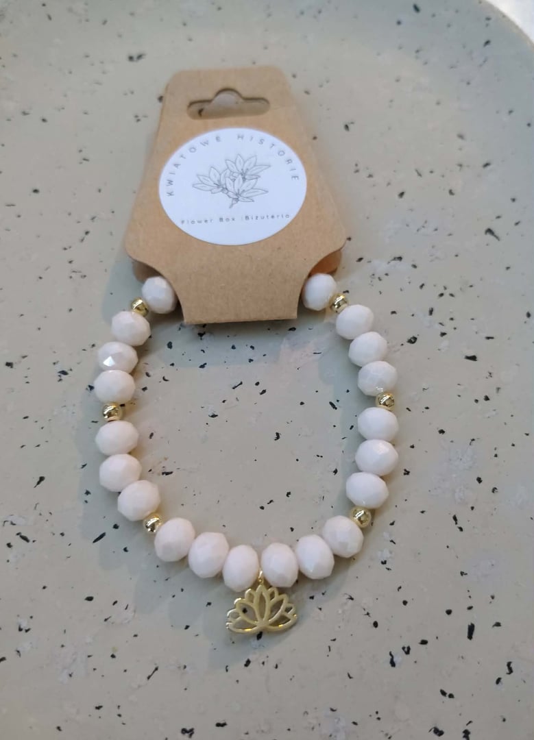 Bransoletka w kolorze pudrowego z dodatkiem złota z lotosem