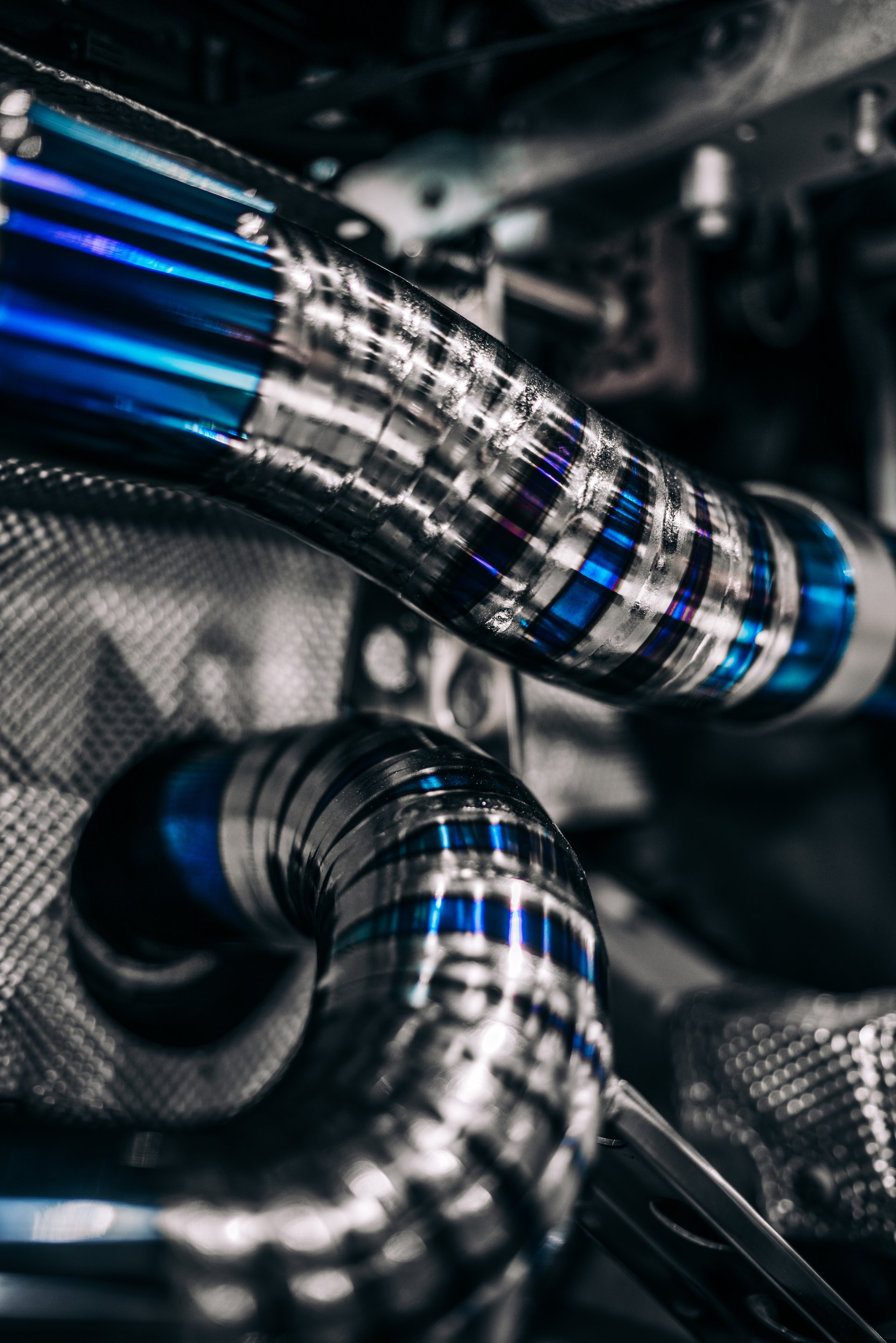 Aftermarket titanium exhaust for a mid engine car