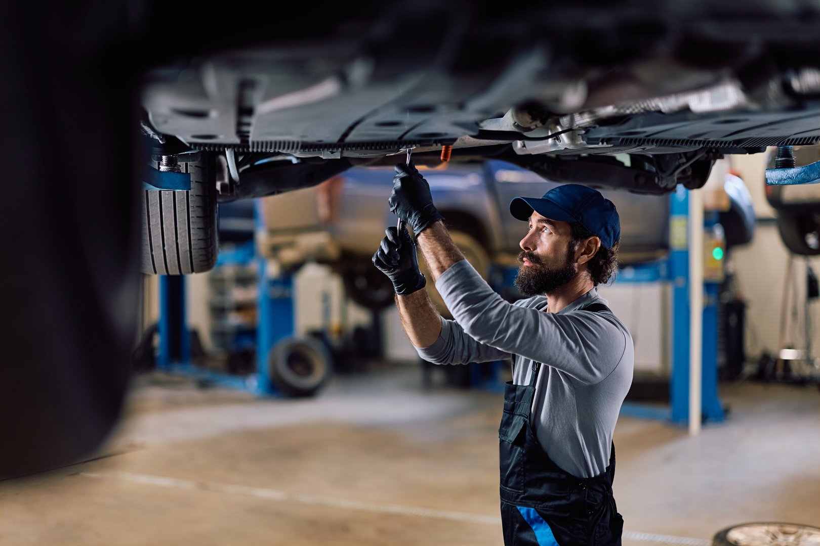Mechanic working on car chassis