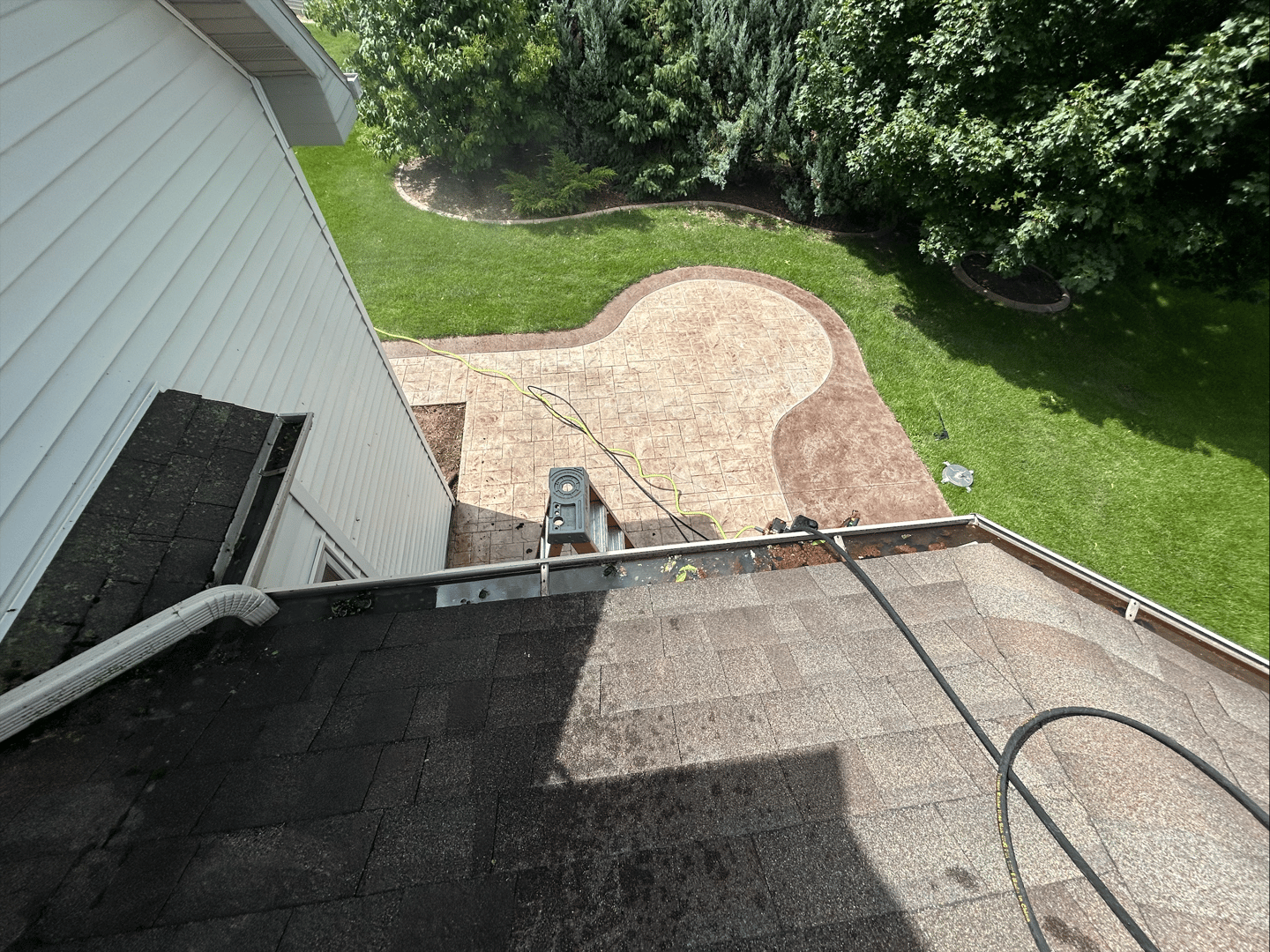 Gutters before cleaning showing dirt and debris