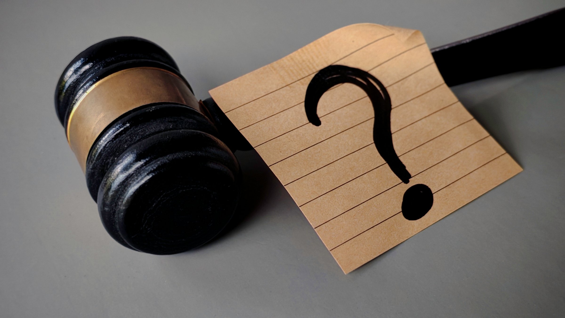 Gavel and Question Mark Representing Legal Uncertainty, Justice Questions, and Court Decision Doubts
