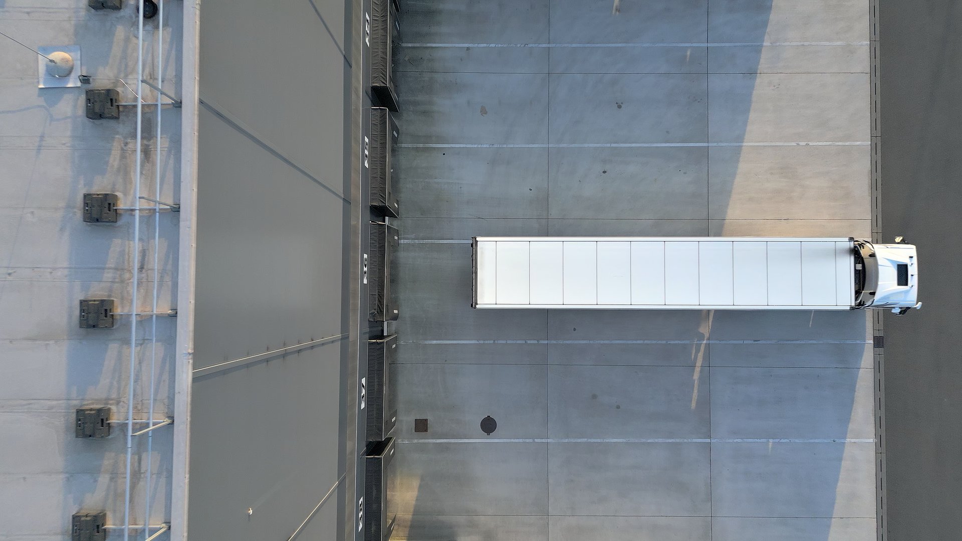 Overhead shot of cargo truck in industrial warehouse for freight transportation and logistics