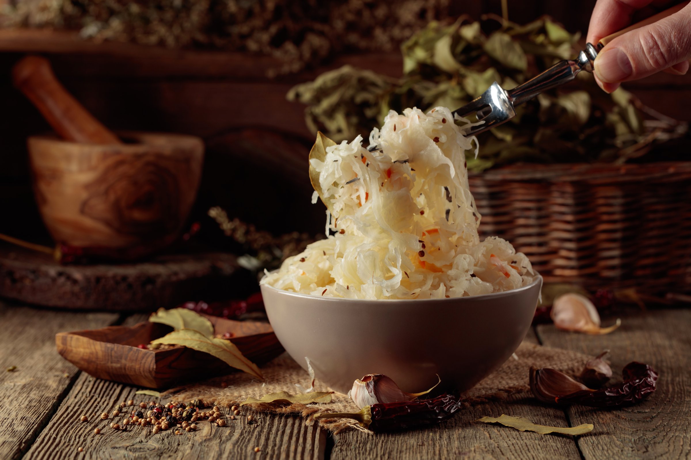 Traditional German sauerkraut with spices on a old rustic wooden table.