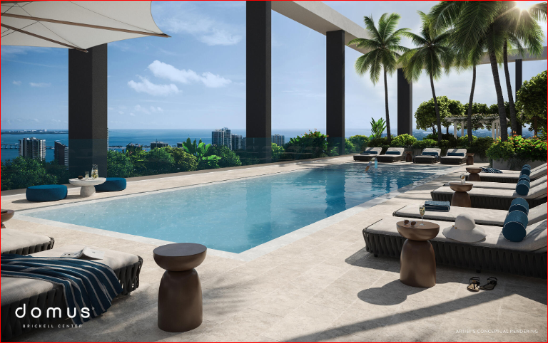 Luxurious rooftop pool area with lounge chairs, palm trees, and ocean view under a blue sky.