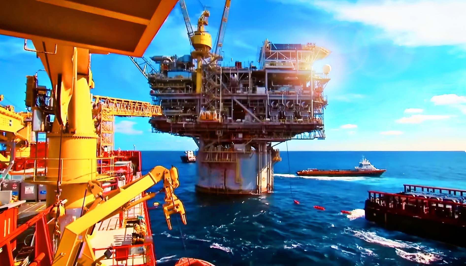 Aerial view of modern offshore oil drilling platform operating in the open sea with support supply vessels nearby. The image highlights the energy sector, petroleum exploration, marine engineering, and industrial infrastructure essential for global oil and gas production. Perfect for themes of energy, fossil fuels, offshore operations, marine logistics, and industrial development.
