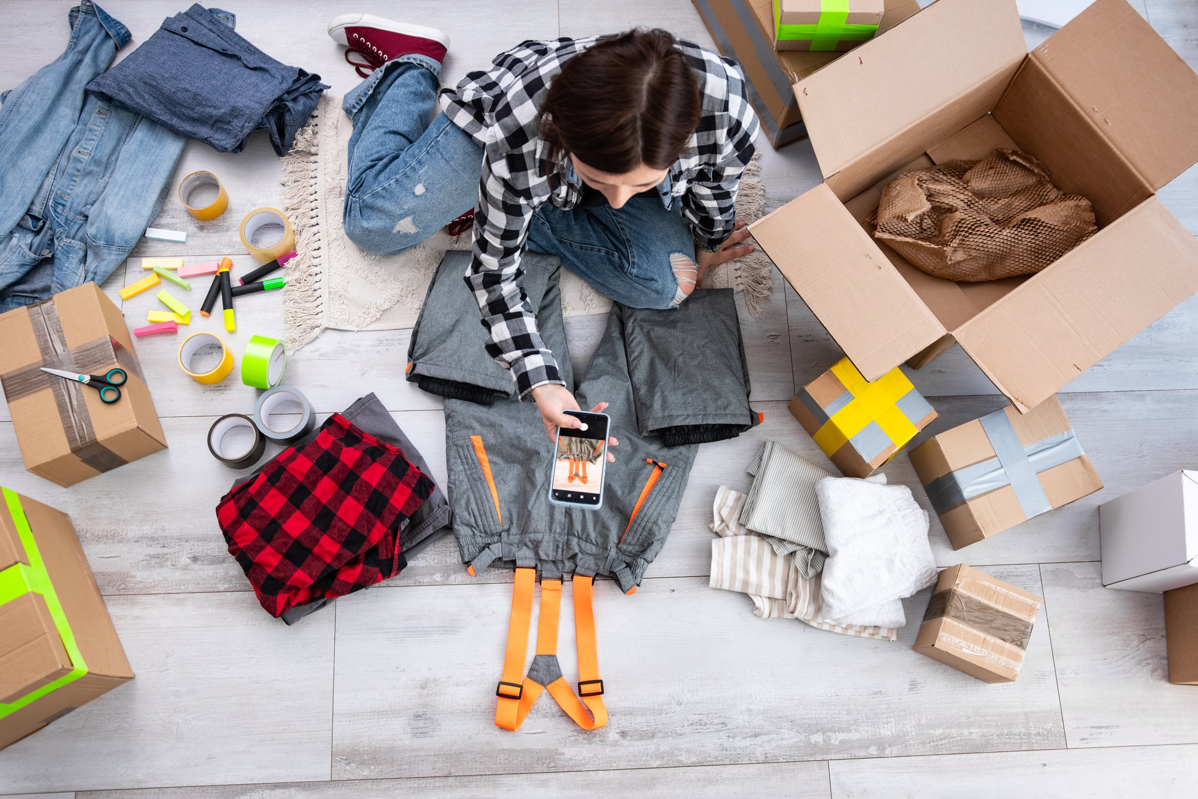 Girl Takes Photos Of Pre-Owned Clothes To Sell Online, Focusing On Selling Second-Hand Items