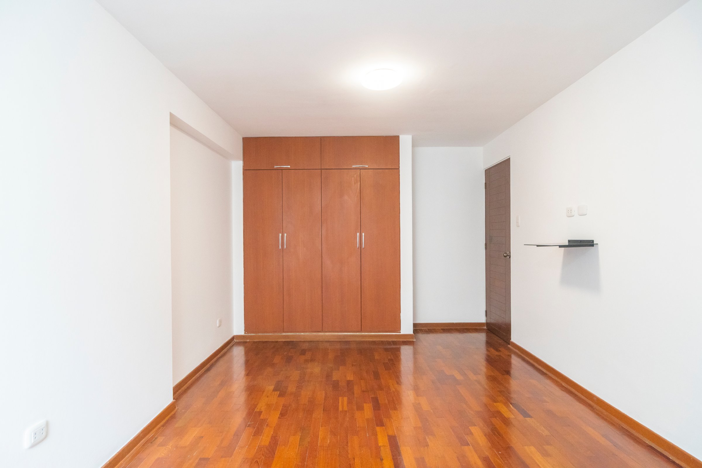 Modern apartment room with white closet