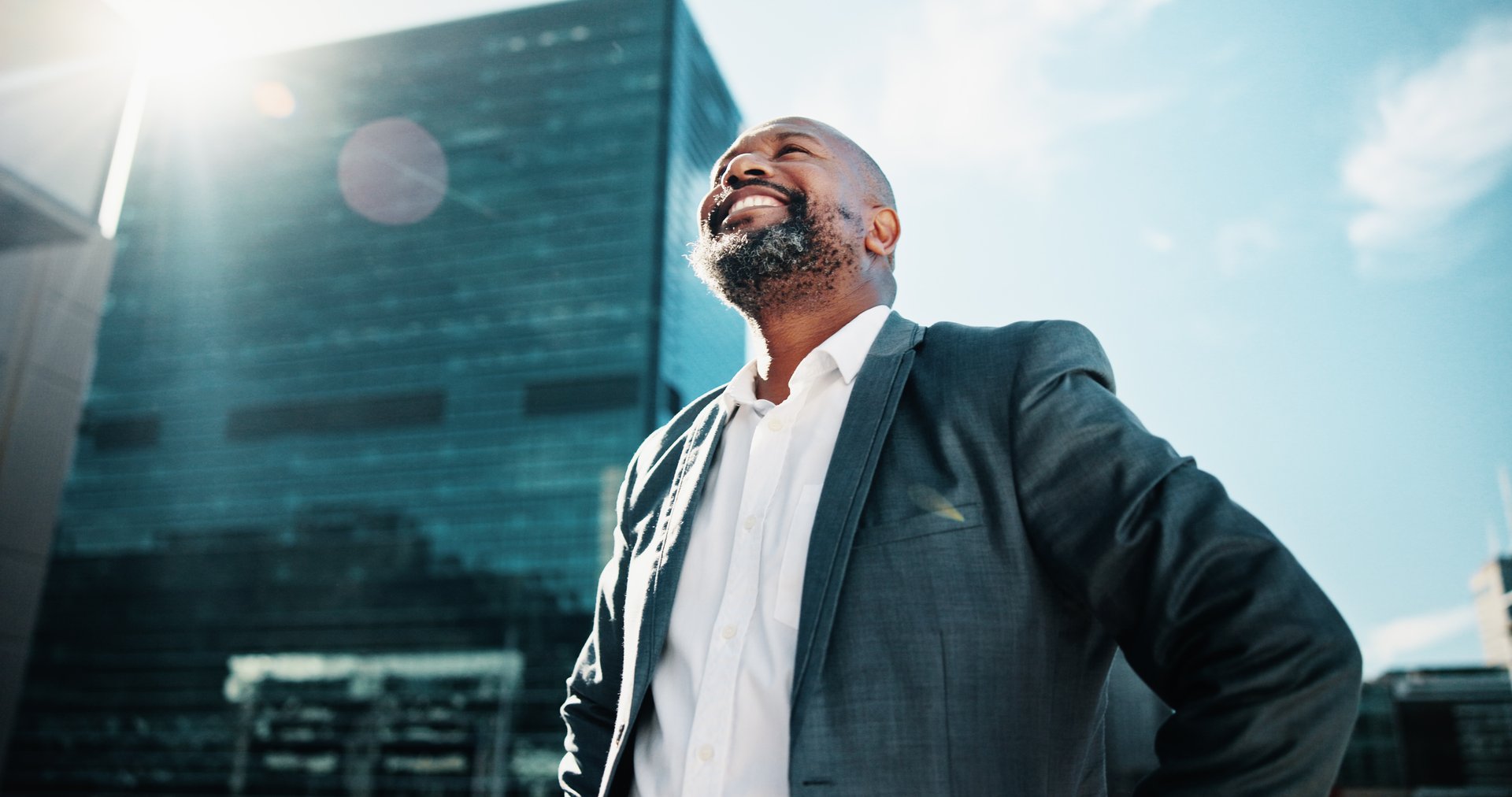 Morning, thinking and business black man in city for idea, brainstorming and career insights. Happy, corporate and person with solution for company future, urban development and job opportunity