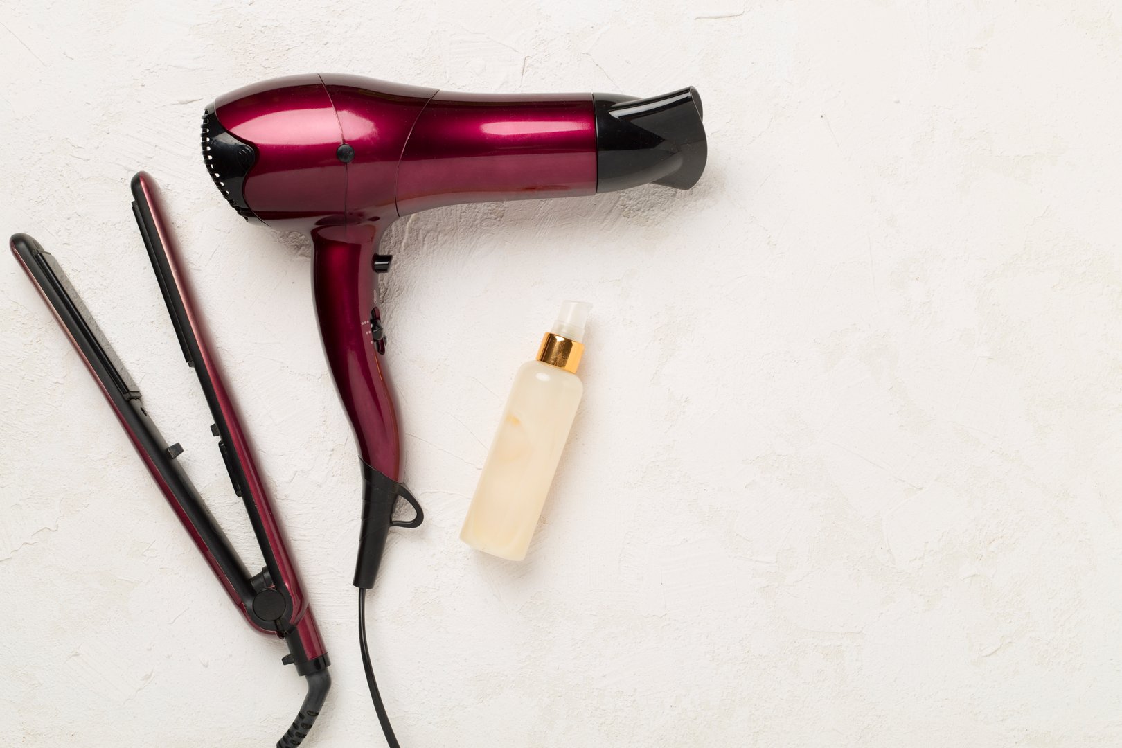 Hair tools with thermo protection on concrete background, top, view