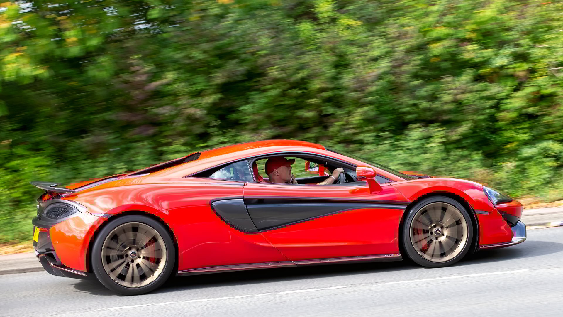Milton Keynes,Bucks,UK - Aug 31st 2025:  2017 red McLaren 570s car driving on a British road